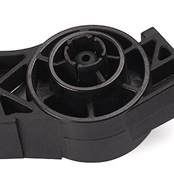Close-up of injection molded pedal pivot hub with radial ribs and bearing seat