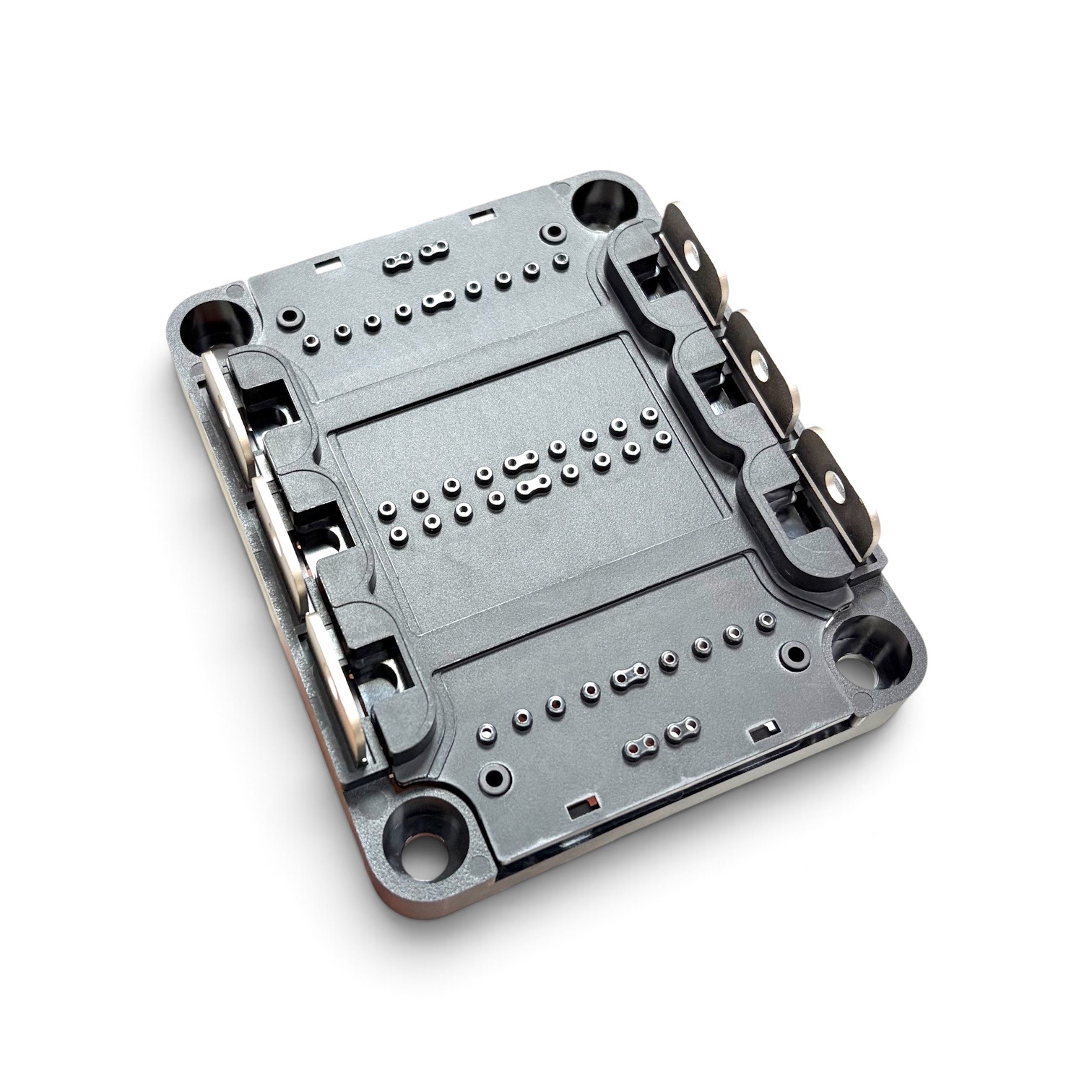 Close-up of precision insert molded power module housing with multiple terminal and contact features