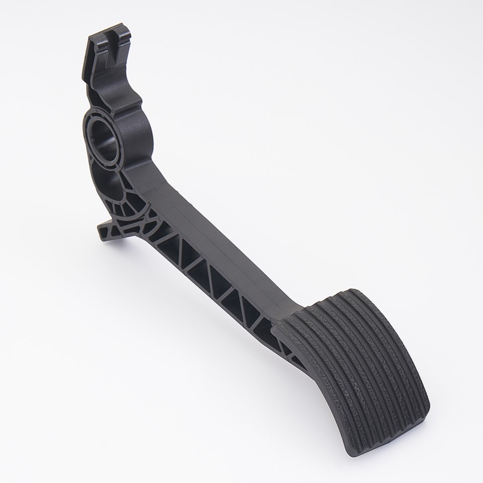 Plastic accelerator pedal arm – injection molding by Ming-Li Precision Glass-fiber reinforced plastic accelerator pedal arm with textured pad, injection molded by Ming-Li